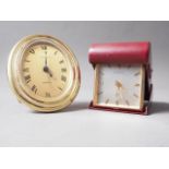 A Bucherer gilt and oval cased quartz travelling clock with gilt dial and Roman numerals, 4" high,