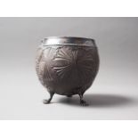 A white metal mounted and lined coconut shell with engraved decoration, on three paw supports, 4 1/