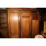 A late 19th century waxed pine wardrobe enclosed three panel doors, 78" wide x 20" deep x 80" high