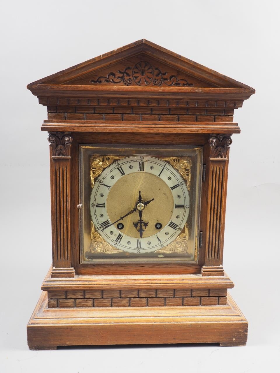 An oak cased mantel clock with carved decoration, silvered and gilt dial, and Roman numerals, on - Image 2 of 4