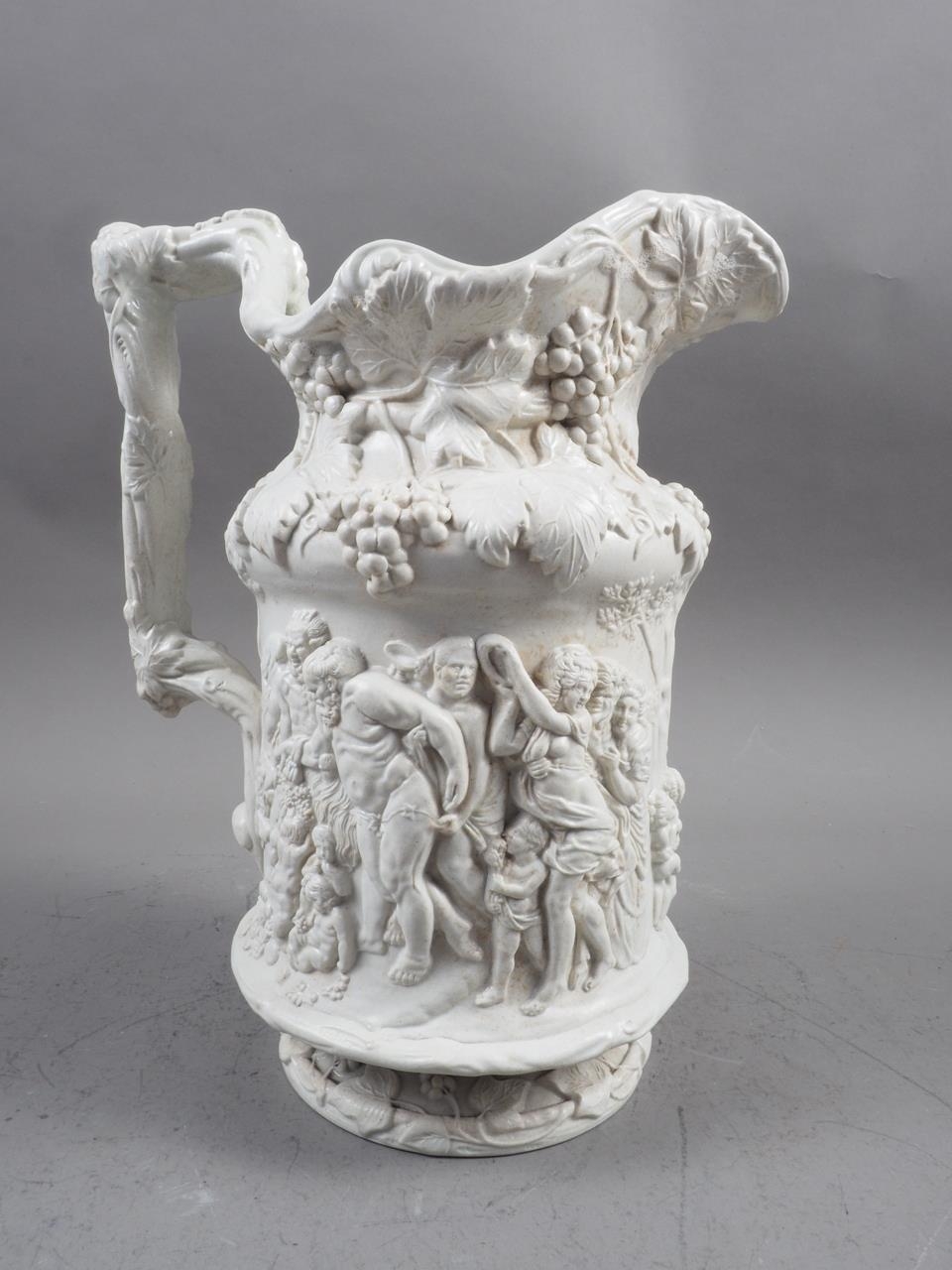 A Charles Meigh 19th century relief moulded jug with Bacchus and Silenus decoration, 10 1/4" high, a