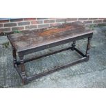 An oak stool of 17th century design, on turned and stretchered supports, 38" long x 13" deep x 17