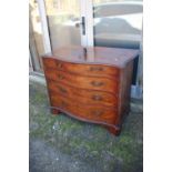 A George III mahogany serpentine front chest of four long graduated drawers with bail handles, on