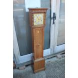An oak long case clock with eight-day striking and chiming movement and brass dial, 52 1/2" high