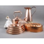 A copper kettle, a copper jug, 10" high, a copper shell-shaped mould, two other moulds and a Royal