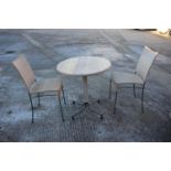 An oak bistro table, on metal splay supports, 25" dia, and a pair of companion chairs