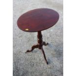 A late 19th century mahogany and fruitwood oval tilt top occasional table, on turned column and