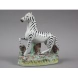A 19th century Staffordshire figure of a zebra, 5 3/4" high (firing fault to base)