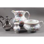 A 19th century floral decorated toilet jug, a companion chamber pot and toothbrush vase, and a