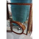 A mahogany framed bevelled edge wall mirror, plate 23" x 35", and an oval wall mirror, plate 20" x