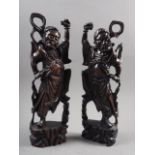 A pair of Oriental hardwood carvings of Immortals, inlaid silver wire, 16" high (one restored)