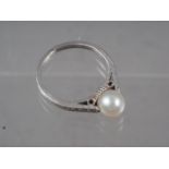 A white metal, pearl and diamond dress ring, size G, 2.5g
