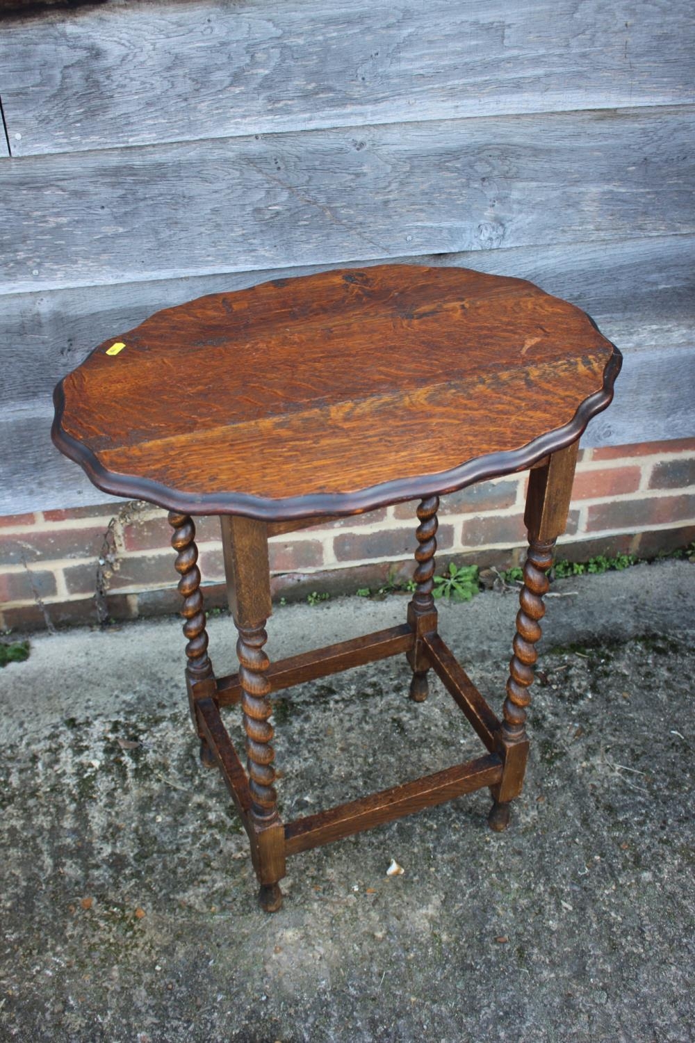 Two oak oval top occasional tables, and a two-tier occasional table
