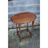 Two oak oval top occasional tables, and a two-tier occasional table