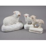 Three 19th century Staffordshire pottery figures of sheep, largest 2 1/4" high (one base restored)