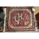 A Kazak style rug with four hooked medallions, 69" x 41" approx (very worn), a floral table runner