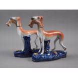 A pair of 19th century Staffordshire greyhounds with rabbits in their mouths, 6" high (
