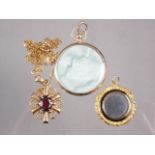 A 9ct gold garnet set pendant, a yellow metal framed locket, and an engine turned and enamelled