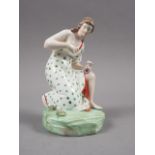 An 18th century Staffordshire polychrome enamel decorated figure of "Flora" picking flowers, on rock