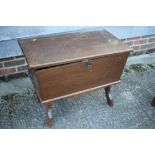 An oak dough bin/sewing box with fitted interior, on panel end supports, 31" wide x 17 1/2" deep x