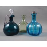 A 19th century green glass jug and stopper, a similar jug and stopper and a Whitefriars type