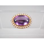 An oval yellow metal and amethyst brooch, 9.3g gross