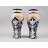 A pair of Royal Doulton silicon ware relief decorated vases with gilt shoulders, 11" high