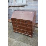 A late Georgian mahogany fall front bureau with fitted interior, over four long graduated drawers,