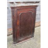 A late Georgian oak and mahogany banded corner hanging cupboard with fluted canted corners, 36" wide