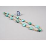 A 9ct gold and turquoise pebble necklace and a silver and synthetic spinel ring