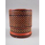 An Oriental red and black lacquered cylindrical box and cover with lift-out trays, 4 1/2" dia