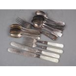 A set of eight silver bottom marked old English bead pattern teaspoons, 4.2oz troy approx, a pair of