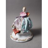 A Capodimonte figure of a seated woman with a fan, 7 3/4" high (restorations)