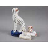A 19th century Staffordshire model of a Dalmatian, on oval base, 7 1/2" high (firing crack to