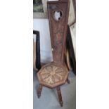 A carved oak spinning stool, on splay supports