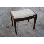 A mahogany dressing stool with dished seat, on reeded supports, 21" wide x 15 1/2" deep x 18 1/2"