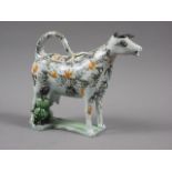 An early 19th century Yorkshire pearlware sponge decorated cow creamer and milkmaid, 5 1/2" high (