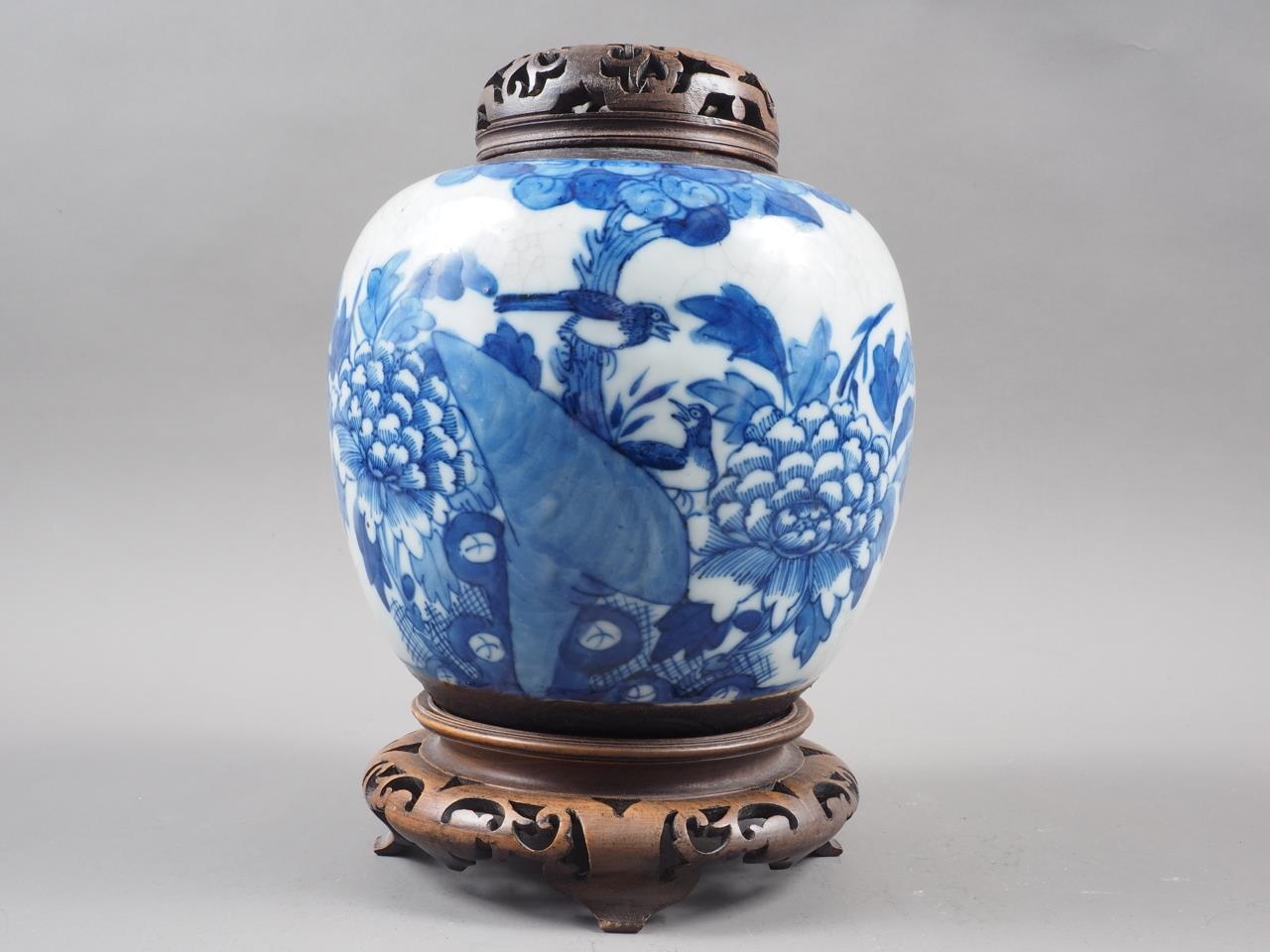 A Chinese blue and white crackle glazed ginger jar with floral decoration, and associated carved