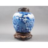 A Chinese blue and white crackle glazed ginger jar with floral decoration, and associated carved