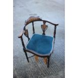 A late Victorian mahogany and inlaid corner elbow chair, on turned and stretchered supports