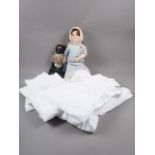 A German bisque headed doll, 21" long overall, another doll and a quantity of lace fabric