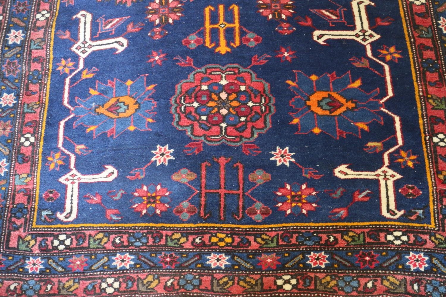 A Kuba rug with three medallions, candelabra and stylised birds on a dark blue ground and triple- - Image 2 of 3