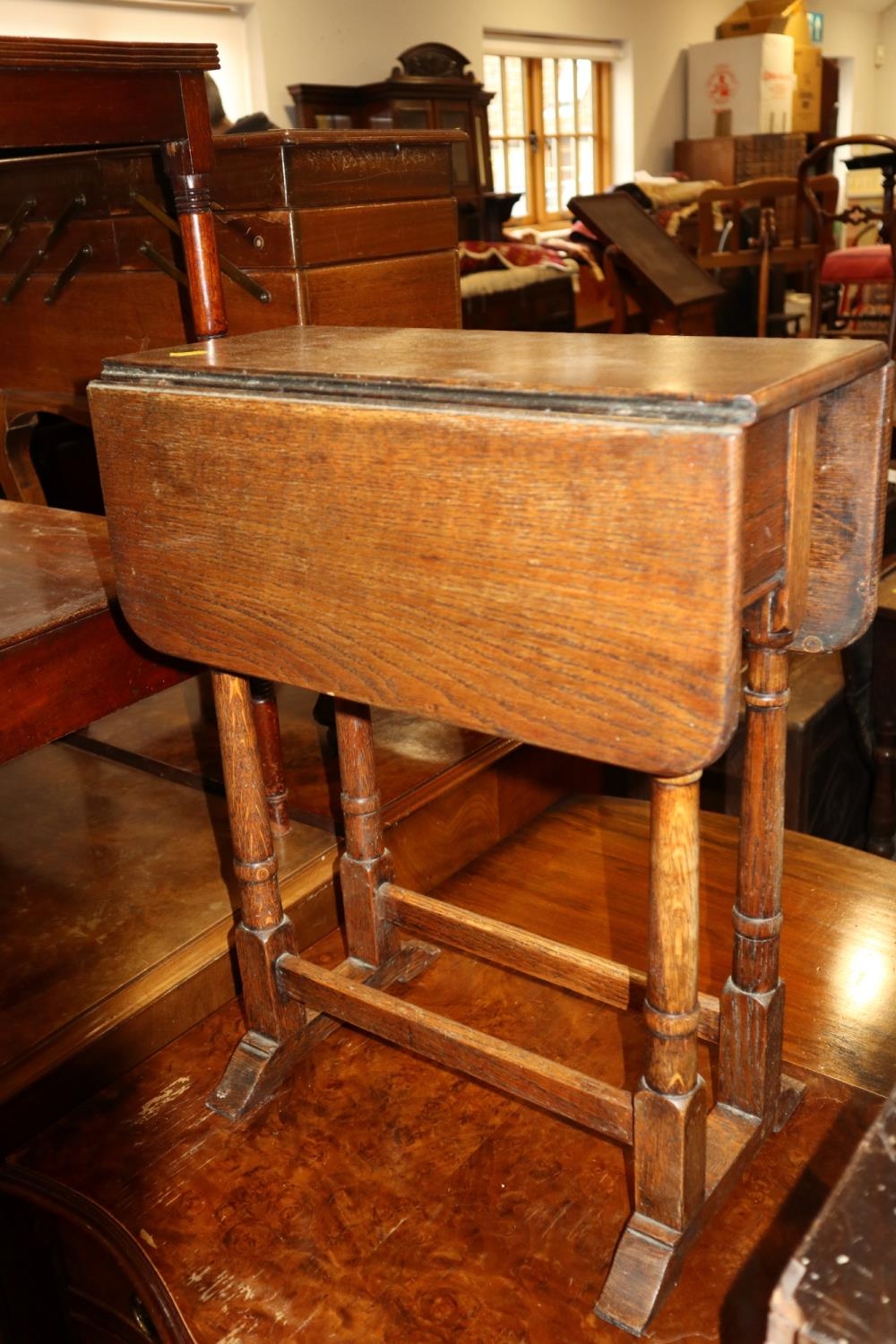 An oak drop leaf occasional table, on turned supports, 18" wide x 22" deep x 22" high, and a