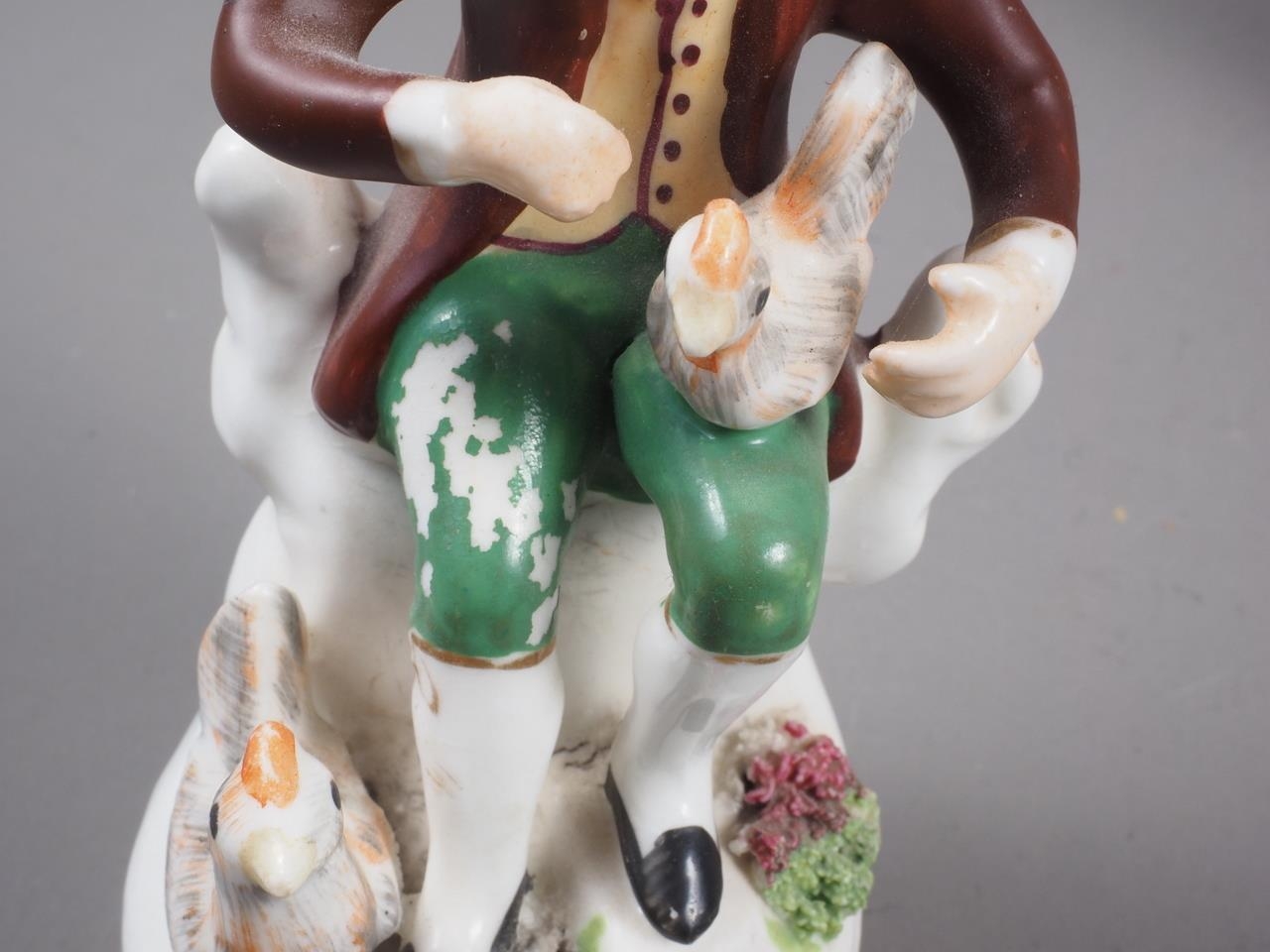 A 19th century Staffordshire bone china figure of a hunter with a rabbit, on rockwork base, 4 1/2" - Image 2 of 2