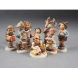 Eight Hummel figures, including "Happy Wanderer", "Schoolgirl" and "Be Patient"