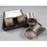 A cased pair of silver napkin rings and four other silver napkin rings, 9.8oz troy approx