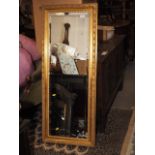 A gilt framed wall mirror with bevelled plate, 13 1/2" x 41 1/2"