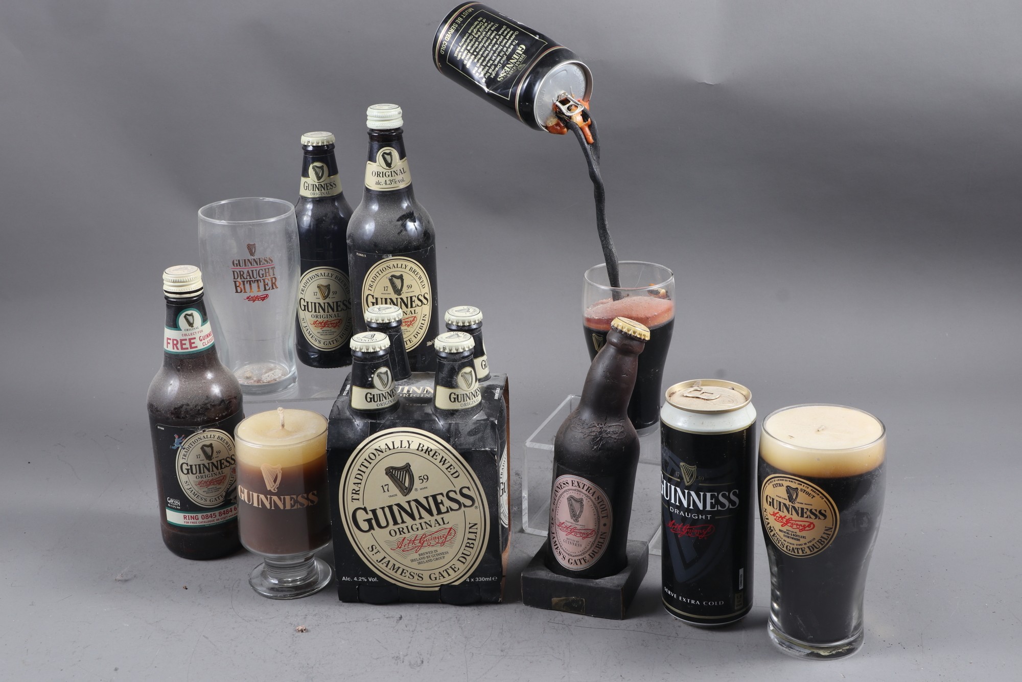 A quantity of Vintage bottled and canned Guinness, candles, tins, etc