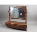 A 19th century mahogany and box line inlaid bowfront toilet mirror, fitted three drawers, on bracket