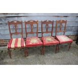 A set of four Edwardian walnut standing dining chairs and a 1930s low seat fireside chair with